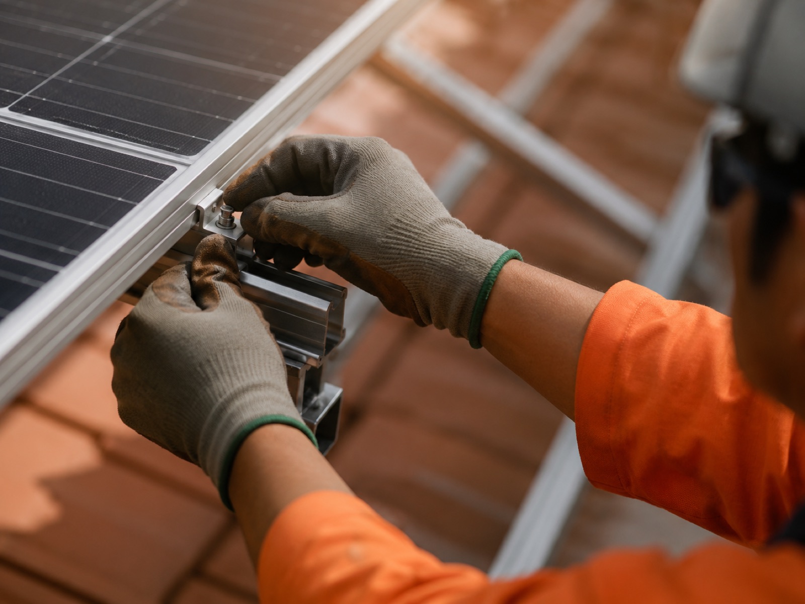 Technician fitting a rooftop solar panel