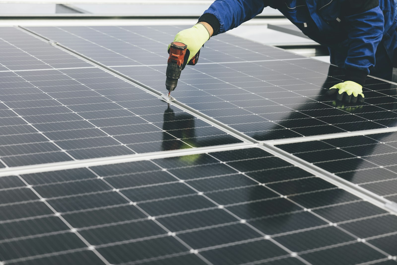 Technician installing rooftop solar panels